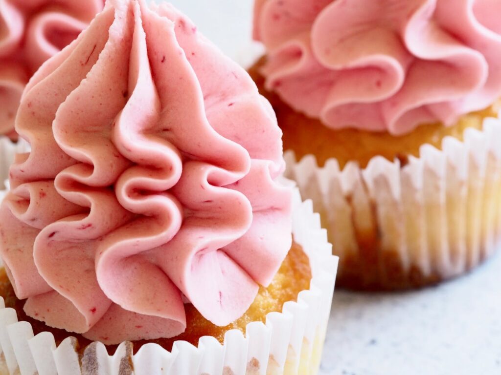 pexels-photo-853006 Delicious close-up image of pink-frosted cupcakes, perfect for dessert enthusiasts.